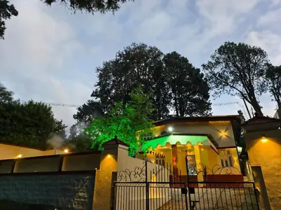 a house with green lights on top of it at Kalanja Greens Nilagiri Villa in Ooty