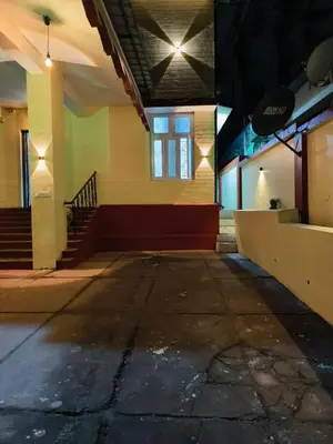 an empty room with a staircase in a building at Kalanja Greens Nilagiri Villa in Ooty