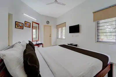 a bedroom with a bed and a tv in it at Palette Nirvana Signature Apartment by CheckIn, Coimbatore in Coimbatore