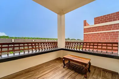 a bench on the balcony of a building at Palette Peace Village by CheckIn | Garden | Breakfast | Erode in Erode