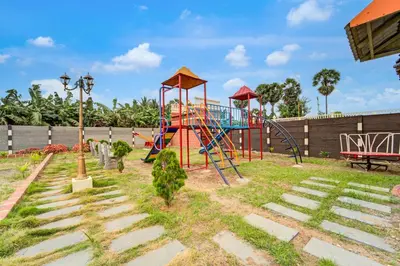 a playground with a slide in a park at Palette Peace Village by CheckIn | Garden | Breakfast | Erode in Erode