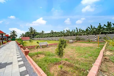 a park with benches and trees in a field at Palette Peace Village by CheckIn | Garden | Breakfast | Erode in Erode