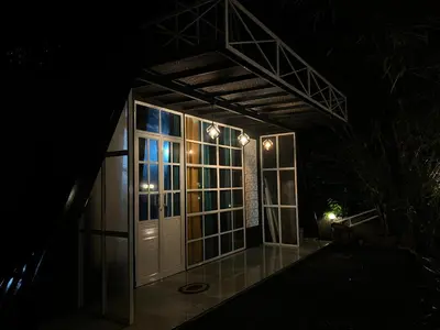a house at night with the door open at The Stellar By Stayzi in Nilambūr