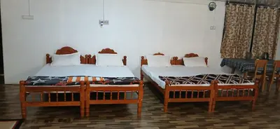 two beds sitting next to each other in a room at BeingWild Resort in Masinagudi