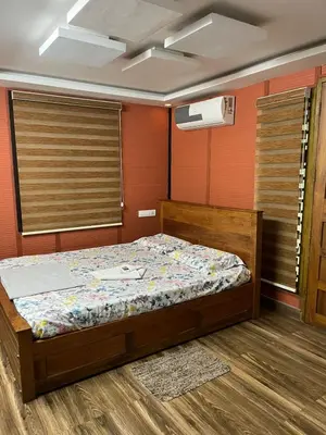 a bedroom with a bed in a room at Apricot Cottage in Kozhikode