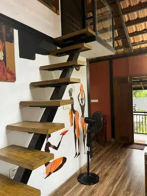 a room with wooden shelves on the wall at Apricot Cottage in Kozhikode