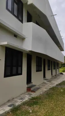 an external view of a building with black windows at Green Valley stay in Pattāmbi