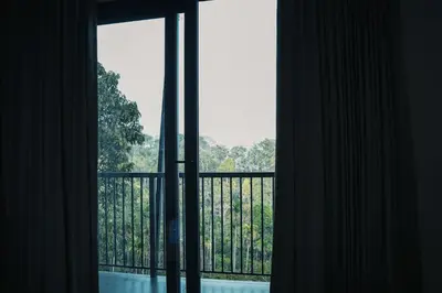 an open window with a view of a balcony at Camplights Stays in Tariyod