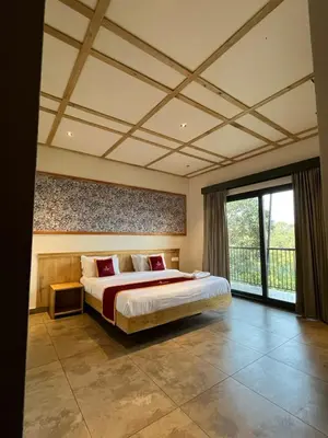 a bedroom with a large bed and a large window at Camplights Stays in Tariyod