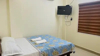 a bedroom with a bed with towels on it at Malayattoor Castle in Kodanad