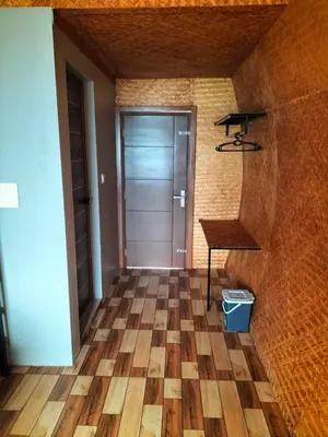 a hallway with a door and a table and a desk at Bhramaram resort in Kanthalloor