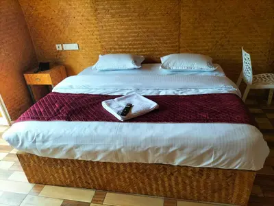 a hotel room with a bed with a towel on it at Bhramaram resort in Kanthalloor