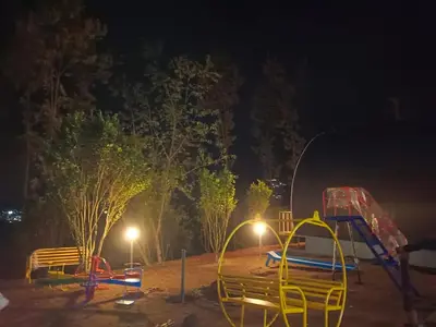 a park at night with two slides and a playground at Bhramaram resort in Kanthalloor