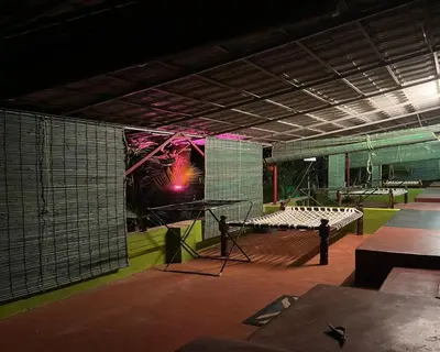 a room with a tennis court with a mural on the wall at The Whistling Pine Woods in Varagampadi
