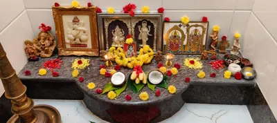 a shrine with flowers and other items on a table at 5 BHK Luxurious & Spacious Villa in Mysuru in Mysore
