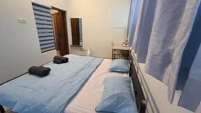 a bed with two pillows on it in a room at 5 BHK Luxurious & Spacious Villa in Mysuru in Mysore