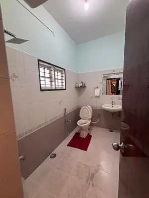 a bathroom with a toilet and a sink at 5 BHK Luxurious & Spacious Villa in Mysuru in Mysore