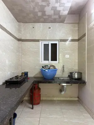 a kitchen with a sink and a bowl on the counter at Murthi's Farm House in Coimbatore