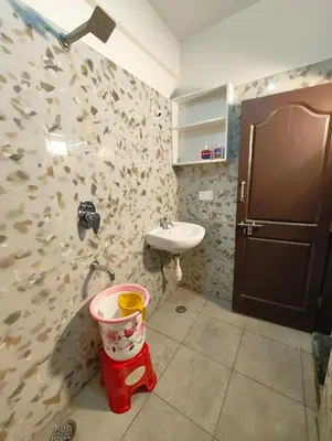 a bathroom with a sink and a bucket at Namasvi 2Bedroom AC House in Narasimharaja Puram