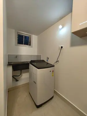 a kitchen with a small refrigerator in a room at Namasvi 2Bedroom AC House in Narasimharaja Puram