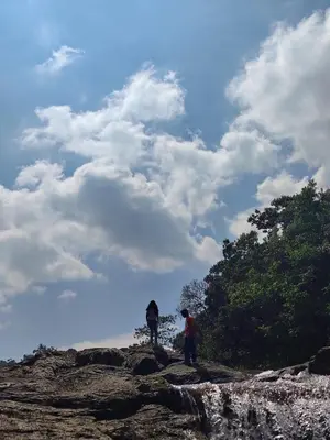 two people standing on top of a rocky hill at Maliyeckal Homes in Viripara