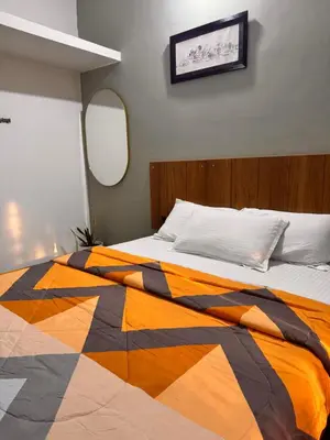 a bedroom with a bed with a colorful blanket at Malma view homestay in Kakkabe