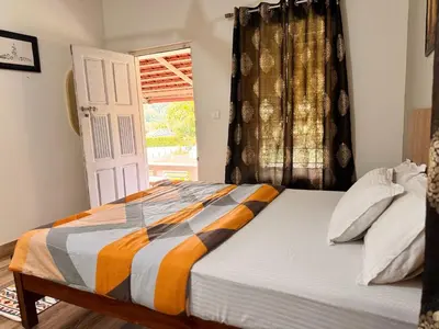 a bed in a room with a window and a door at Malma view homestay in Kakkabe