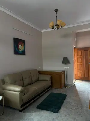 a living room with a couch and a door at Villa Vista in Mysore