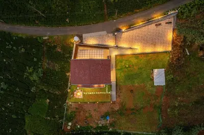an overhead view of a building with lights on it at Riverstone Haven in Kotagiri