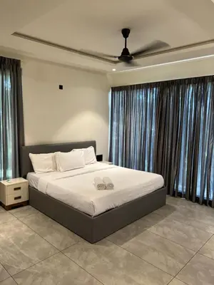 a bedroom with a bed with two wedding shoes on it at Tree Valley Resort Wayanad in Meppādi