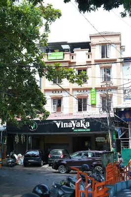 a building with a sign that reads vivanazka on it at Vinayaka Tourist Home in Kozhikode