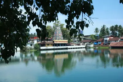 a temple sitting on top of a body of water at Vinayaka Tourist Home in Kozhikode