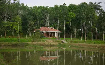 a house sitting next to a body of water at Aquatica by bough'n villa in Kenichira