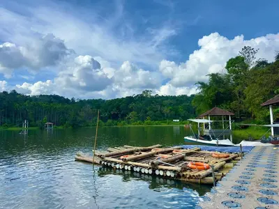 a boat is docked at a dock on a lake at Karlad Lake Palace Waterfront Resort by stayRAa in Tariyod