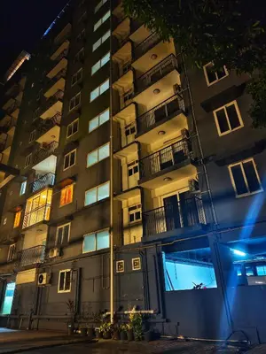 a tall apartment building at night with lights on at krishna paadham in Guruvāyūr