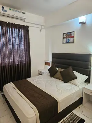 a bedroom with a large bed and a window at krishna paadham in Guruvāyūr