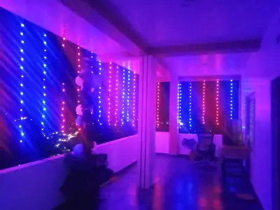 a room with purple and blue lights on a wall at Cherry Blossom in Kotagiri