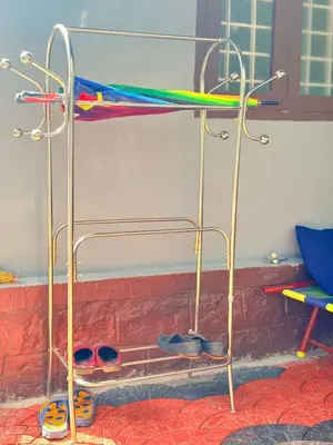 a shelf with shoes on it in a room at sahara dua jungle farmstay in Wayanad