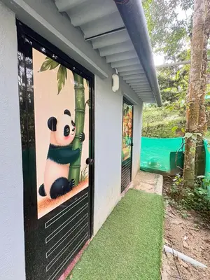a panda picture on the door of a house at sahara dua jungle farmstay in Wayanad