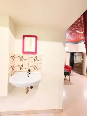 a bathroom with a sink and a mirror on the wall at sahara dua jungle farmstay in Wayanad