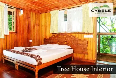 a bed in a tree house with a tree house interior at Cybele Hill Resort in Kalpetta