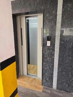 a door with a mirror in a room at Aangal residency in Coimbatore