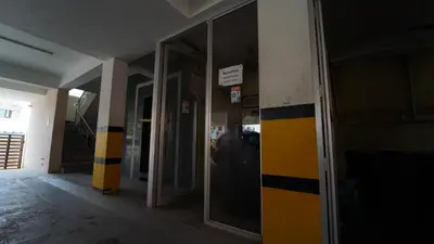 an entrance to a building with yellow and black stripes at Aangal residency in Coimbatore