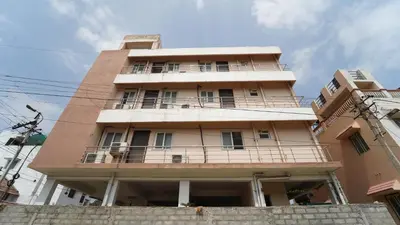 a building with a balcony on top of it at Aangal residency in Coimbatore