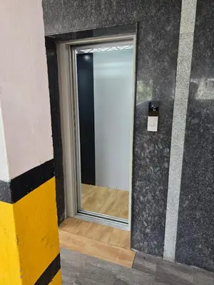 a mirror on the side of a room with a wall at Aangal residency in Coimbatore