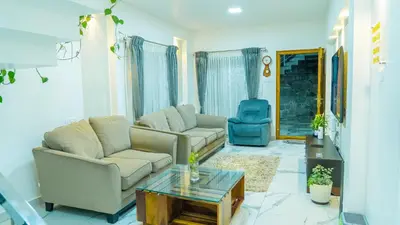 a living room with two couches and a coffee table at The Moon Graceful Villa in Ketti