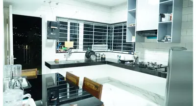 a kitchen with black and white appliances at The Moon Graceful Villa in Ketti