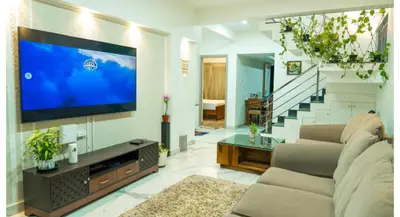 a living room with a large flat screen tv at The Moon Graceful Villa in Ketti
