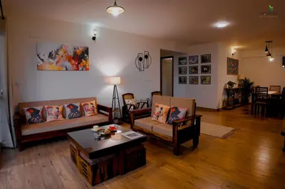 a living room with couches and a coffee table at Hope Horizon Luxury Villa By LexStays in Coonoor