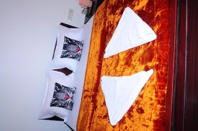 a wooden cutting board with white napkins and socks at A L Residency in Ooty